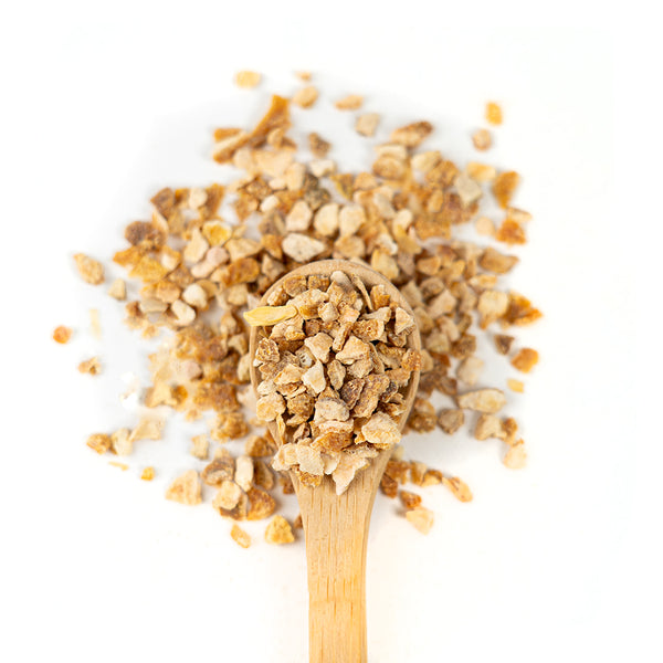 Wooden spoon of Organic Lemon Peel on a white background.