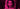 Woman with curly hair under pink light on a dark background.