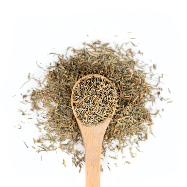 Wooden spoon of Organic Thyme on a white background.